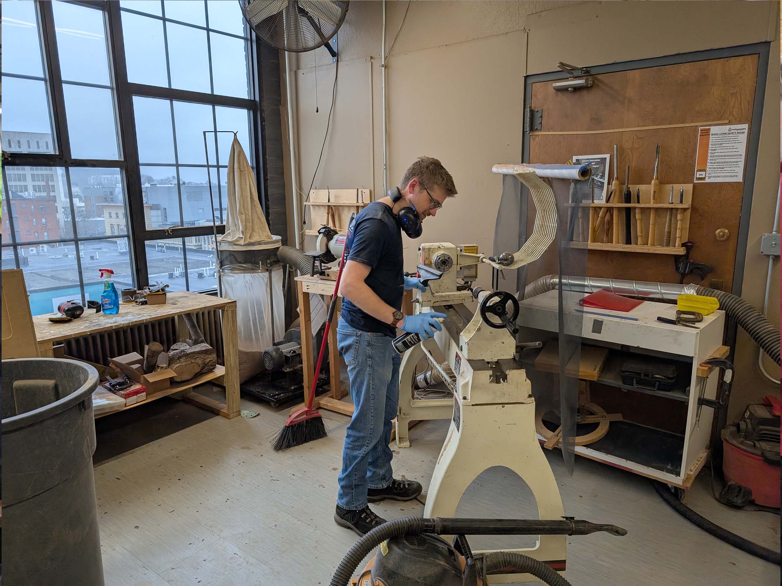 Jonathan cleaning the wood lathes at Shop Day